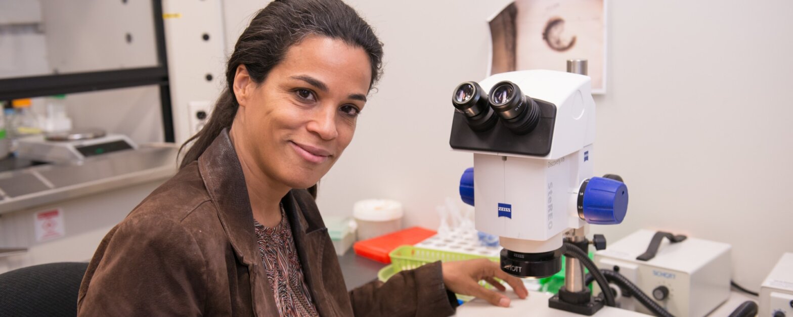 woman in front of a microscope