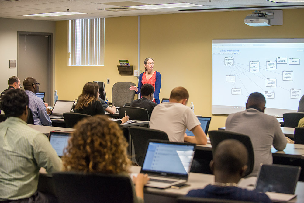 Professor showing students a network diagram in a classrom