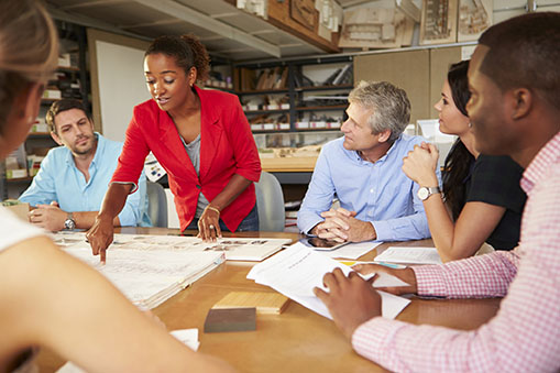Diverse group of professionals actively engaged at a conference room table