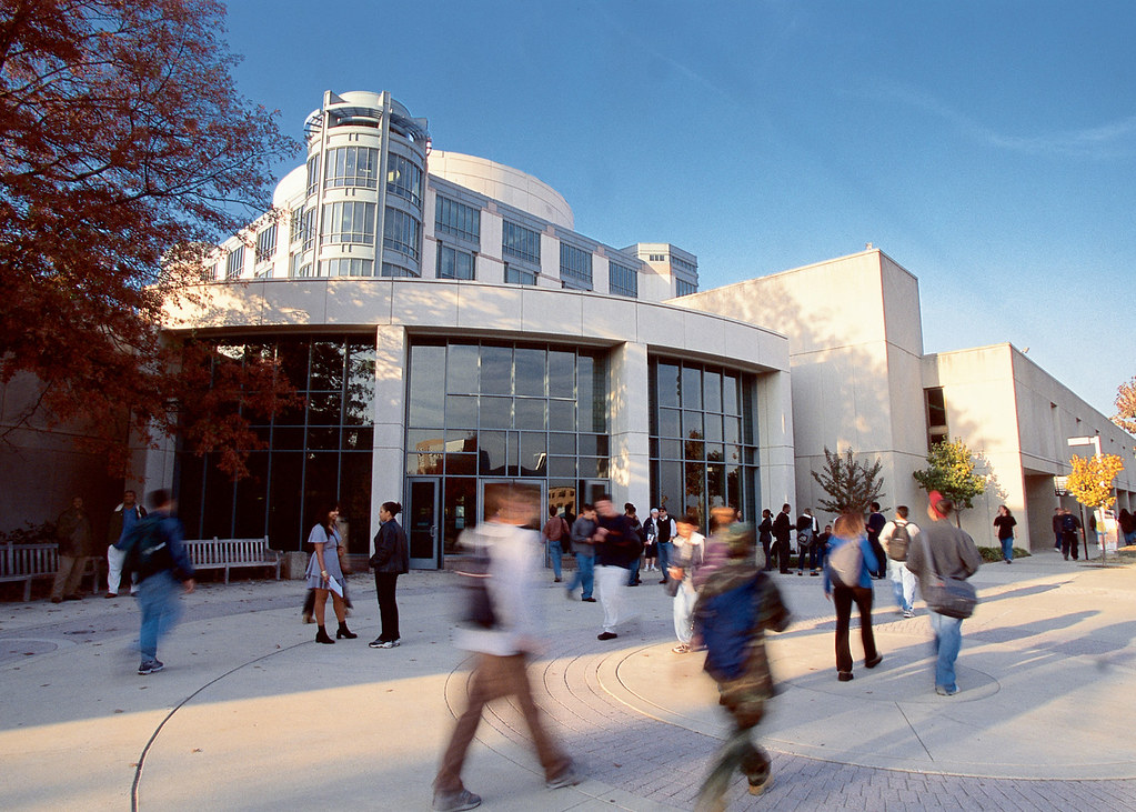 Outside the Albin O. Kuhn library with students passing by