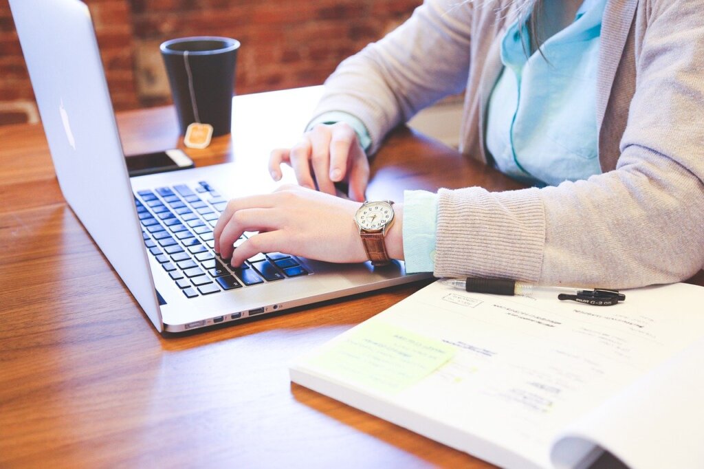 professional typing on a computer.