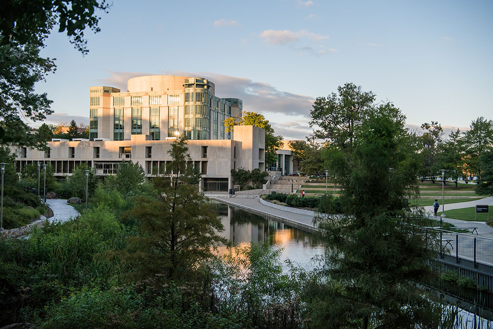 Sun setting on library and pond