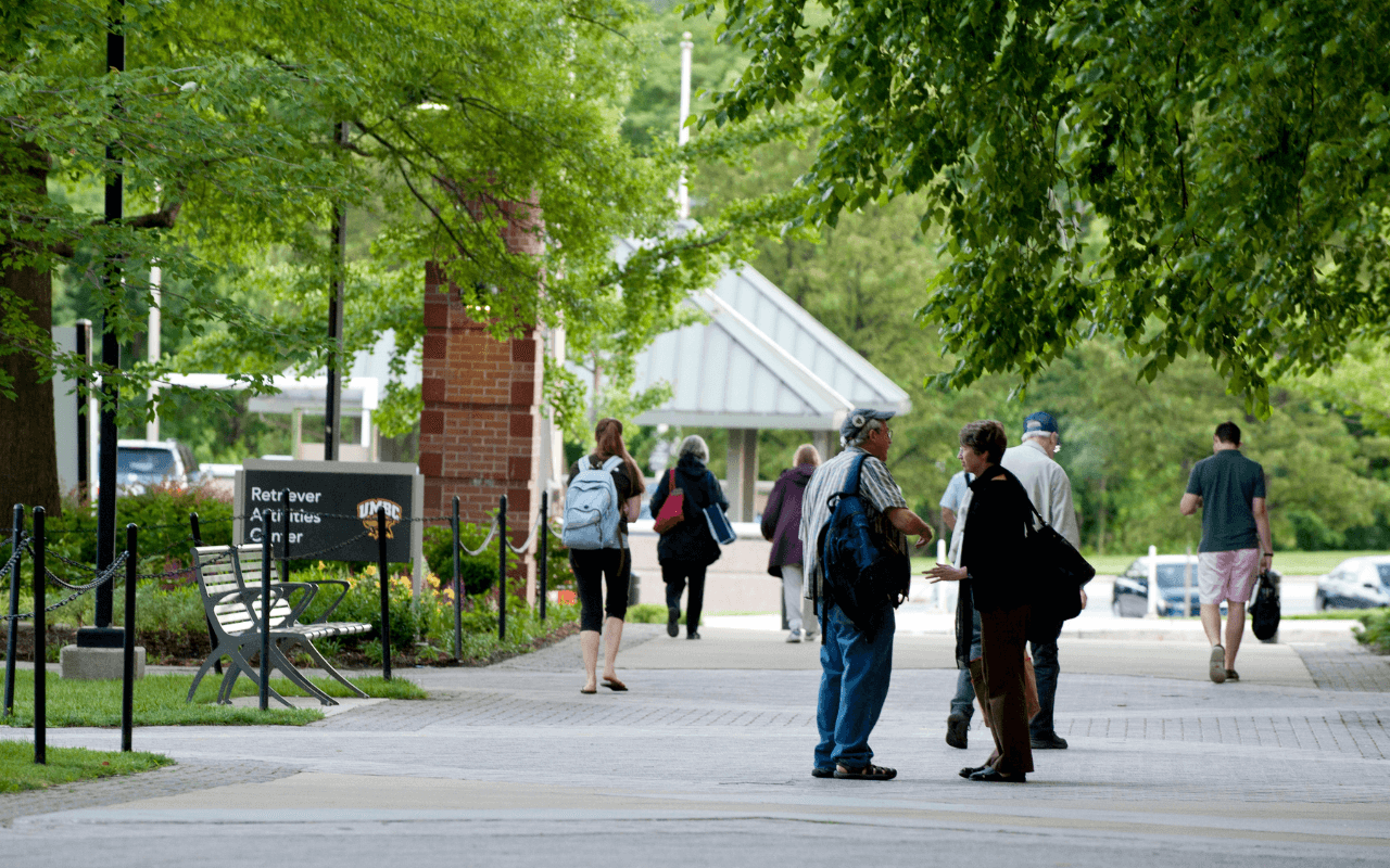 A photo of campus where two people are networking. Keep in mind that when you network using Linkedin you can build more connections.
