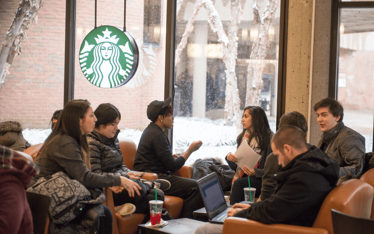 Students conversing in the University Center Starbucks