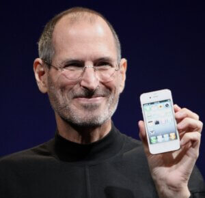 Portrait of Steve Jobs holding an iPhone