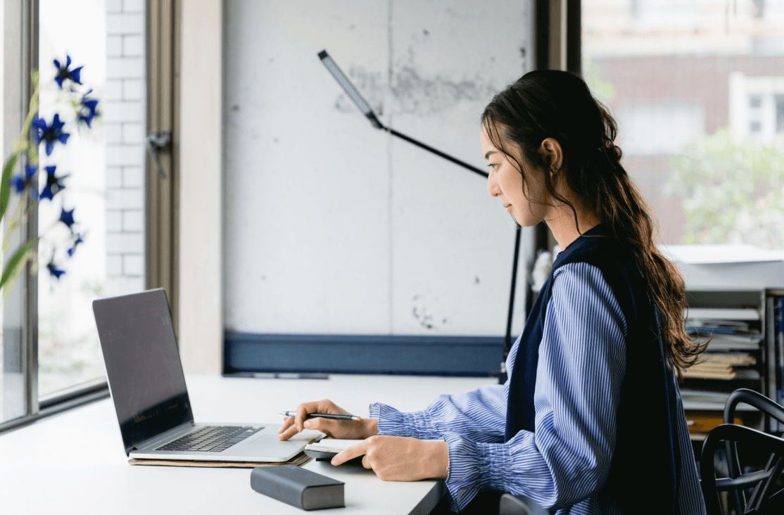 Person typing on a computer using AI tools to enhance productivity and workflow