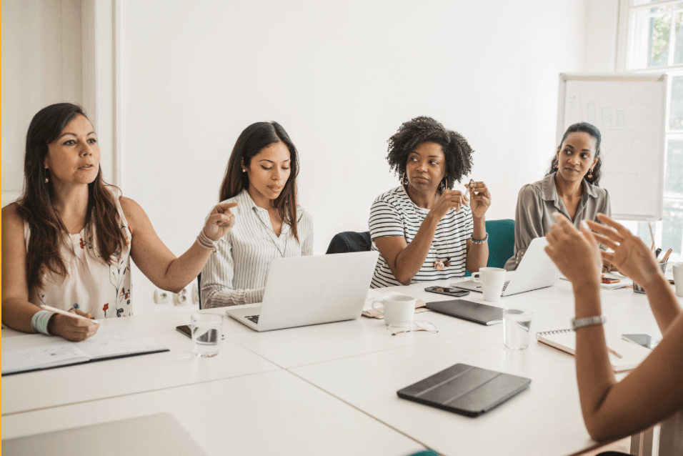 Professional woman at a table exploring health IT careers leveraging your experience