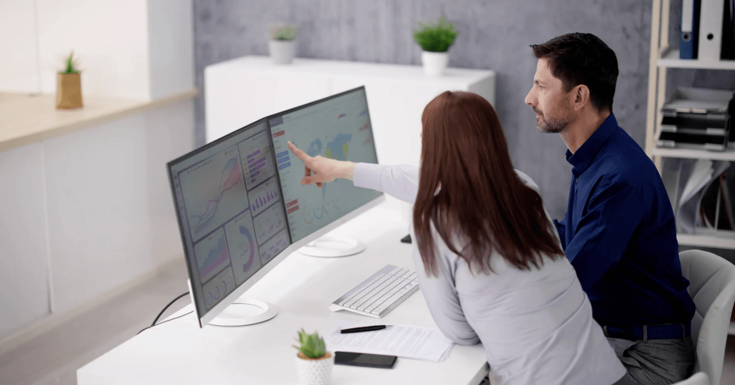 Two people looking at a computer screen with data visualizations and analytics charts during a Teach Yourself Data Science learning or collaboration session.