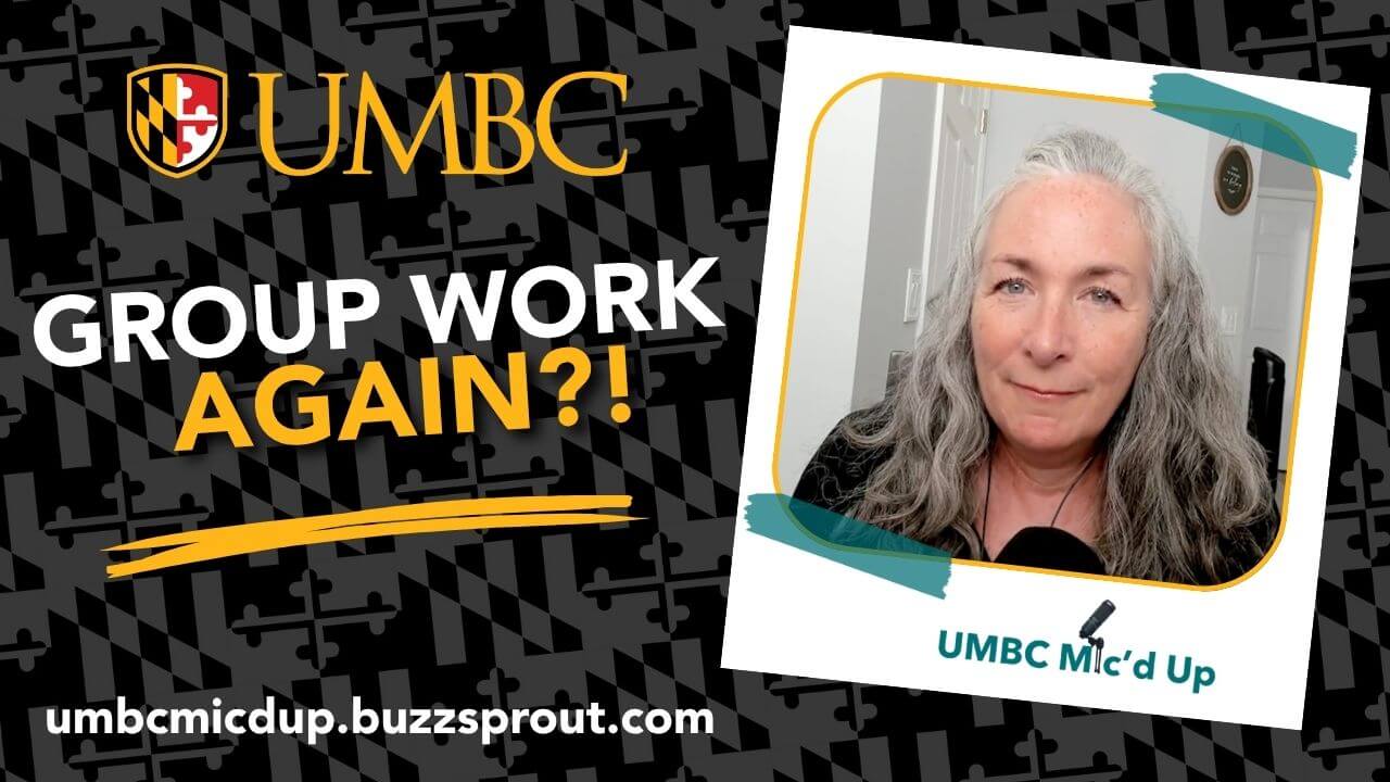 Promotional banner for the podcast "UMBC Mic'd Up" set against a black background with a dark gray Maryland flag pattern. On the left side, the UMBC crest and name appear above the bold text "GROUP WORK AGAIN?!" in white and gold lettering with a brushstroke underline. Below this, the website URL "umbcmicdup.buzzsprout.com" is displayed in white text. On the right side, a tilted photo frame features a woman with long, gray wavy hair, with the "UMBC Mic'd Up" logo at the bottom of the photo frame.